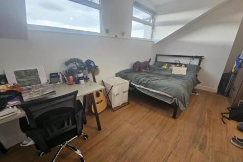 A bright, well-maintained bedroom featuring a c...