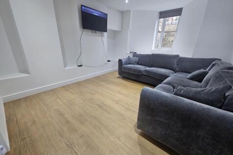 A spacious and bright living room featuring mod...