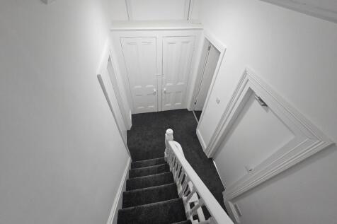 Bright, well-maintained staircase hallway with ...