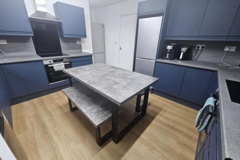 A modern, well-maintained kitchen with sleek bl...