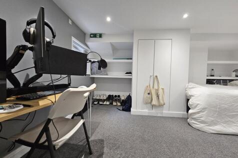 A well-maintained bedroom featuring a comfortab...