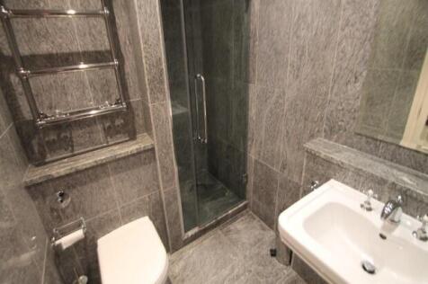 A modern, clean bathroom with a white toilet an...