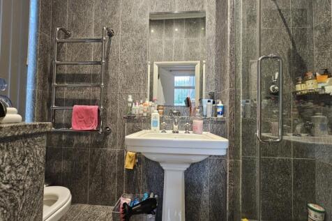 Modern bathroom with a sink, mirror, and shower...