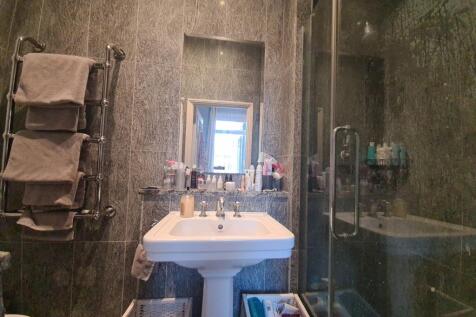 A modern bathroom with a large sink and ample s...