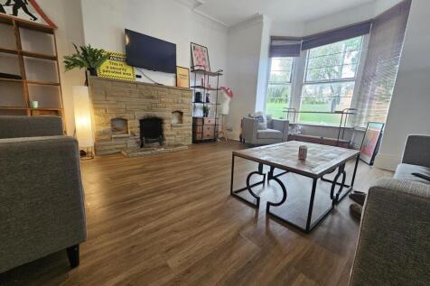 Bright and welcoming living room featuring a la...