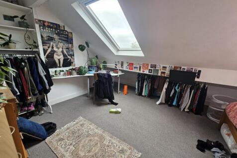A bright and cozy bedroom with a skylight windo...