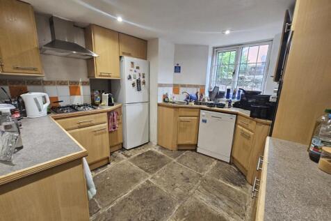 A well-maintained kitchen with ample natural li...