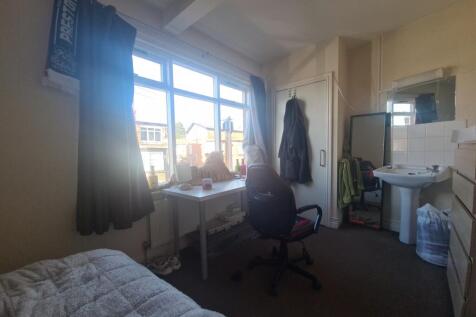 A bright and spacious master bedroom with large...