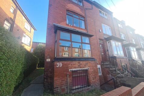 A welcoming front facade of a brick residential...