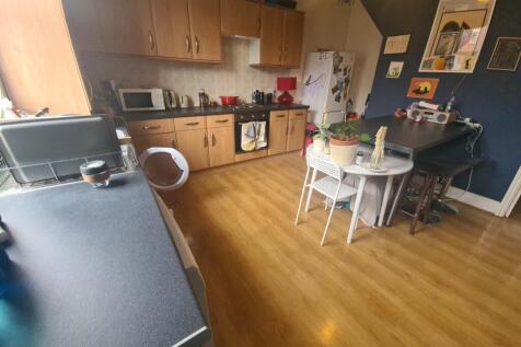 A bright and welcoming living room featuring wo...