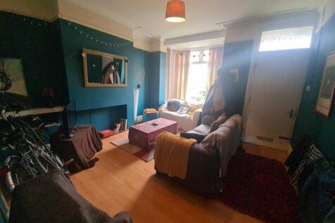 A cozy, well-lit living room with a comfortable...