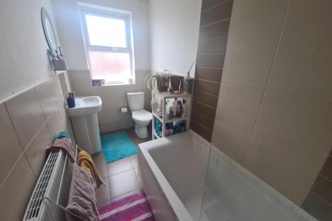 A well-maintained bathroom featuring a large ba...