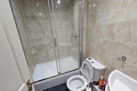 A spacious and modern bathroom featuring a larg...