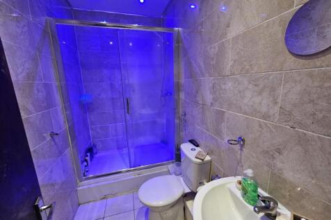 A modern bathroom featuring a large shower with...