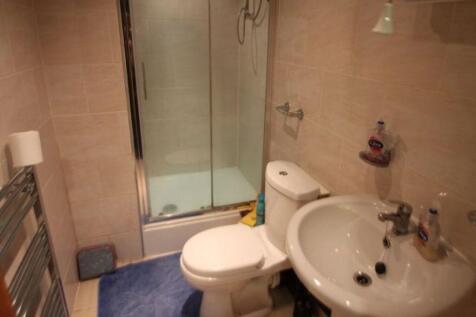 A well-maintained bathroom with a toilet, sink,...