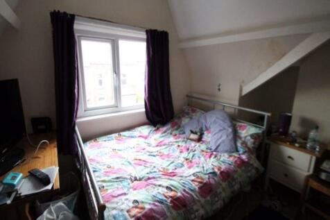 A spacious and bright bedroom featuring a doubl...