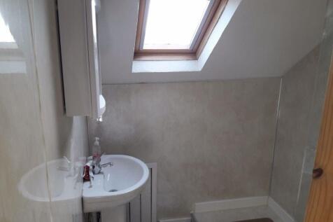 A bright and clean bathroom with a white sink a...
