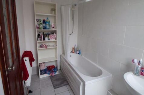 A clean, modern bathroom with a spacious bathtu...