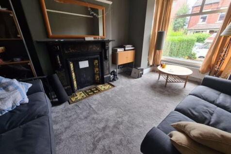 A cozy and well-maintained living room featurin...