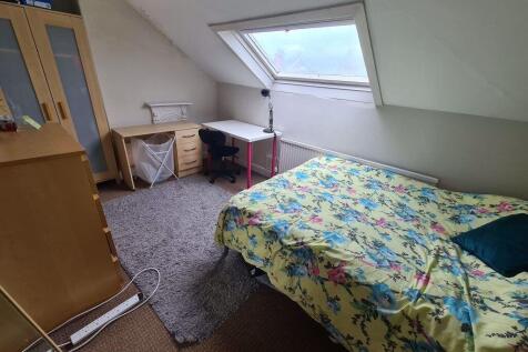 A spacious and bright master bedroom featuring ...