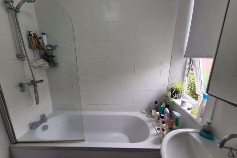 Bright and well-maintained bathroom featuring a...