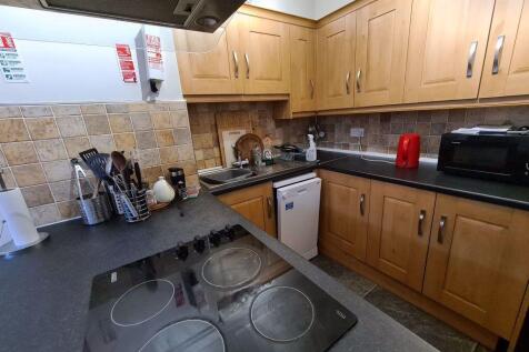A well-organized kitchen with wooden cabinets, ...