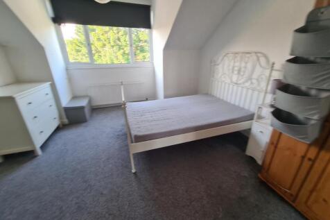 A bright and cozy bedroom featuring a single be...