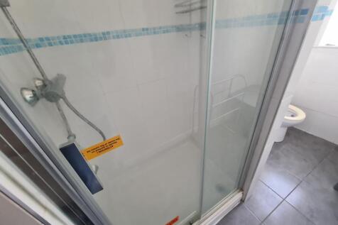 A clean and well-maintained bathroom with a sho...