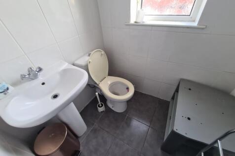 A clean and functional bathroom with a sink, to...