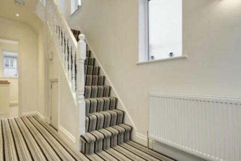 Bright, well-maintained entrance hallway with a...