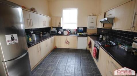 Bright modern kitchen with U-shaped worktops, i...