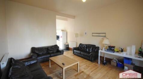 Bright communal lounge with wood flooring, mult...