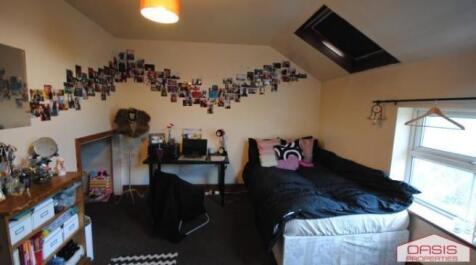 Bright upstairs double bedroom with a raised be...