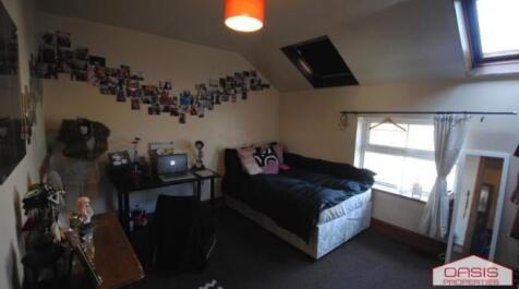 Cosy furnished bedroom with a double bed, desk ...