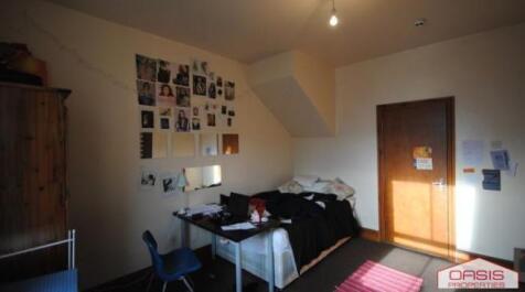 Bright, simply furnished double bedroom with a ...