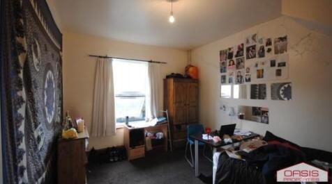 Cozy furnished bedroom with a double bed, desk ...