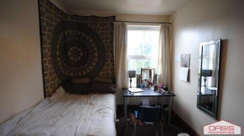 Cozy furnished bedroom with a single bed, desk ...