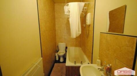 Compact bathroom with a bathtub, toilet and sin...