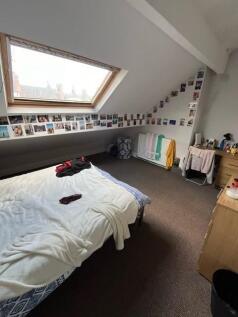 Bright attic-style double bedroom with a large ...