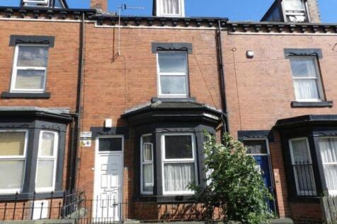Well-maintained terraced brick house with a bay...