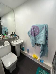 Modern bathroom with white sanitaryware, wall-m...