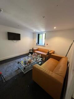 Comfortable communal lounge with two modern lea...