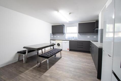Bright modern kitchen with dark cabinetry, inte...