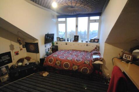 Cozy double bedroom with a patterned double bed...