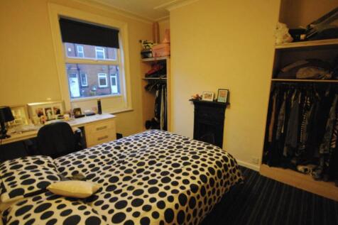 Bright, neatly presented bedroom with a pattern...