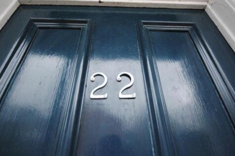 Glossy dark-blue front door with silver house n...