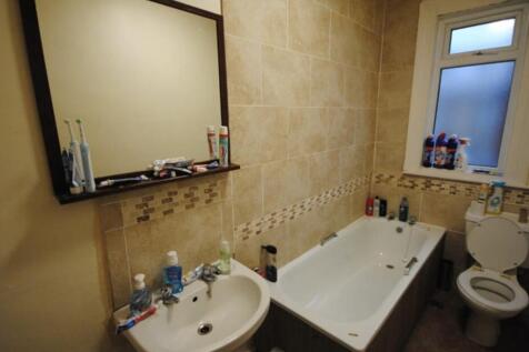 Tiled bathroom with a full-size bathtub, pedest...