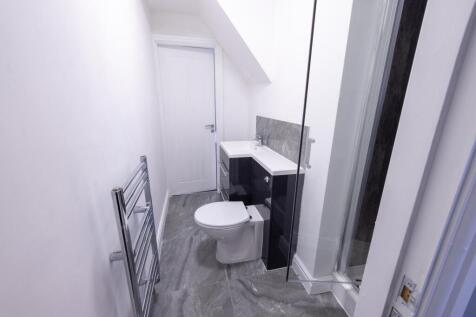 Bright modern bathroom with a walk-in shower, v...