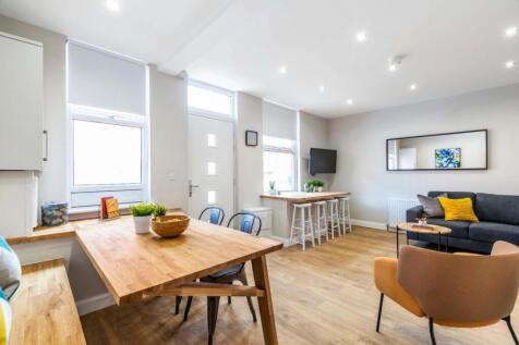 Bright, modern open-plan living area with comfy...