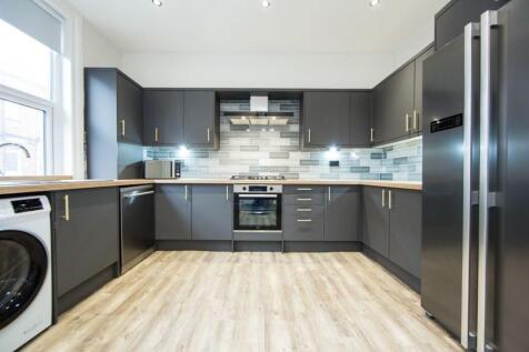 Contemporary fitted kitchen with sleek grey cab...